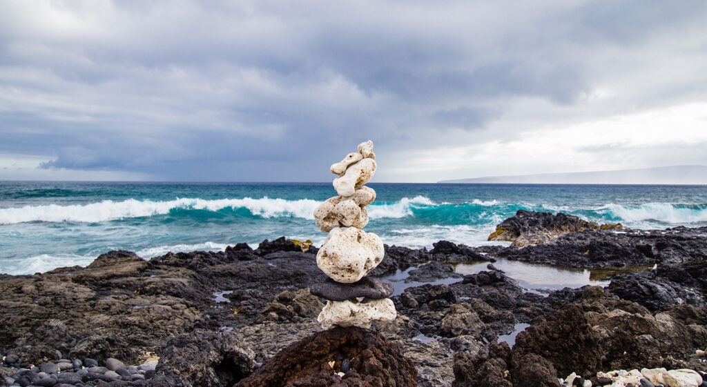 Rocks stacked in front of the ocean